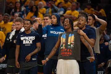 The Wolves bench reacts to an Anthony Edwards dunk Saturday night in Game 3.